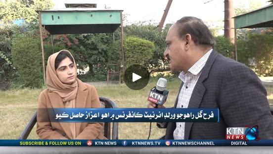 Speaker presenting at a conference with a big screen behind